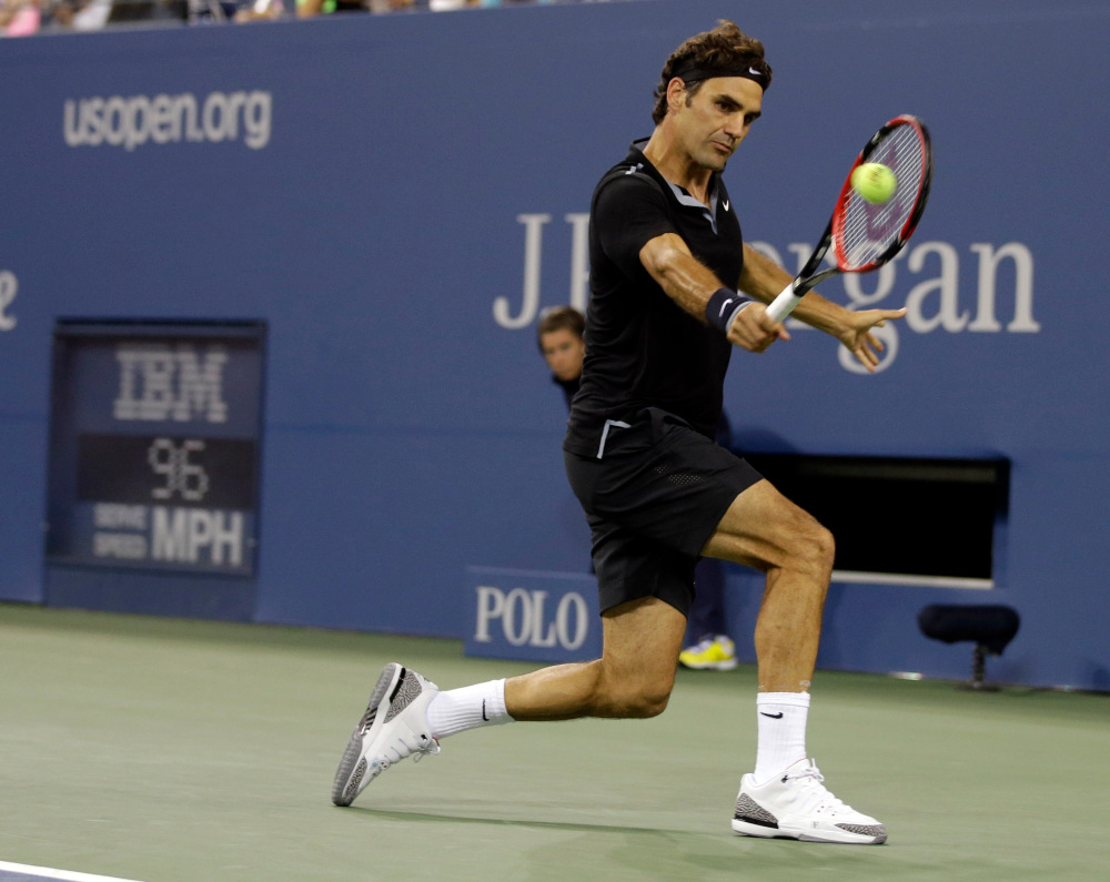 Roger Federer, of Switzerland, returns a shot to Marinko Matosevic, of Australia, during the first round of the 2014 U.S. Open tennis tournament Tuesday, Aug. 26, 2014, in New York. (AP Photo/Darron Cummings) ORG XMIT: USO510