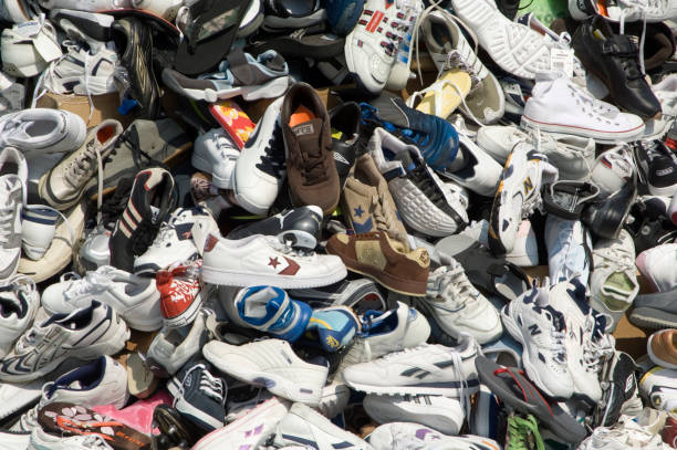A large pile of various models of shoes
